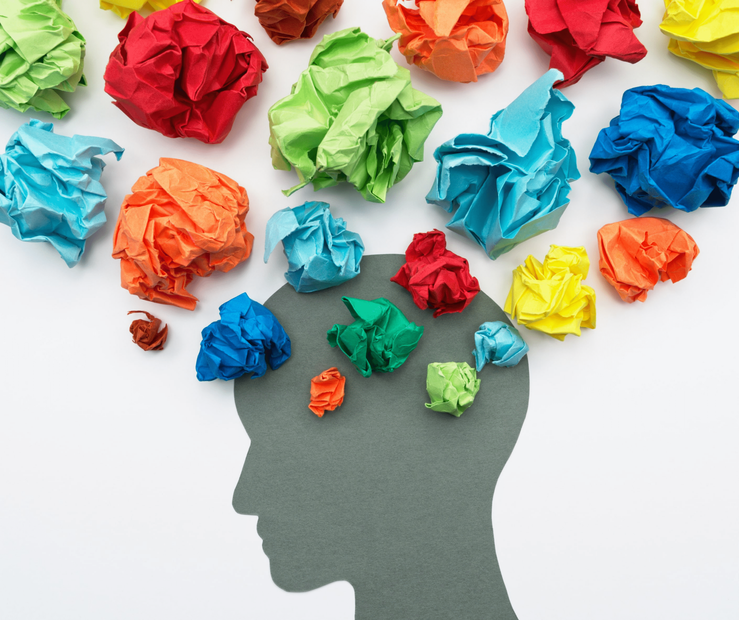 a person's head with crumpled colorful paper balls