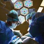 a group of surgeons performing surgery - helping people is a reason to become a doctor
