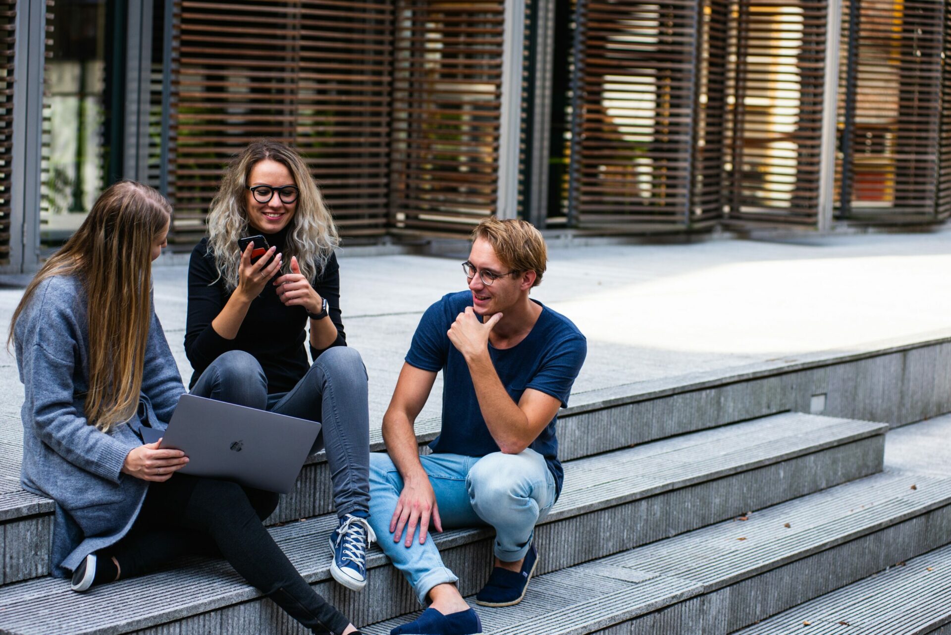 Students having a discussion in an outdoor setting.