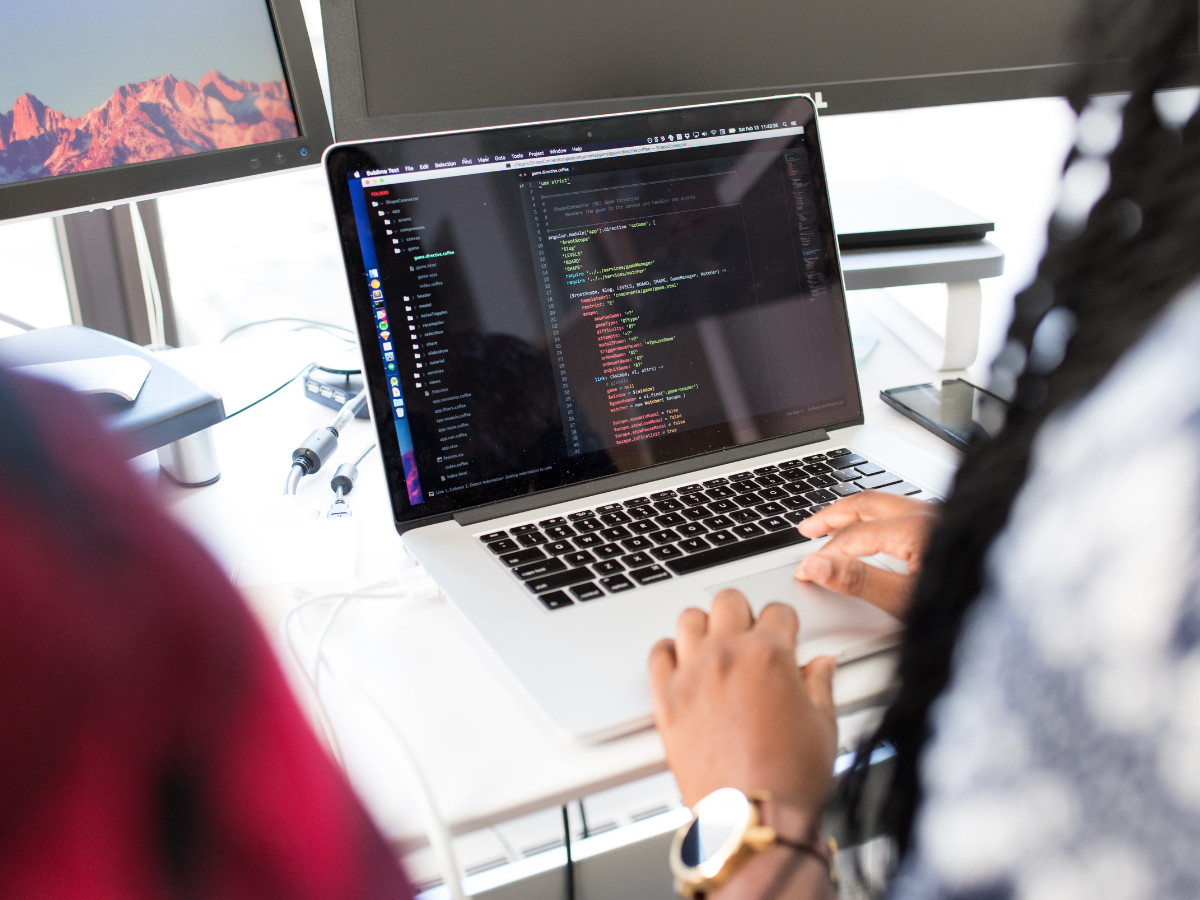 a person coding on a laptop