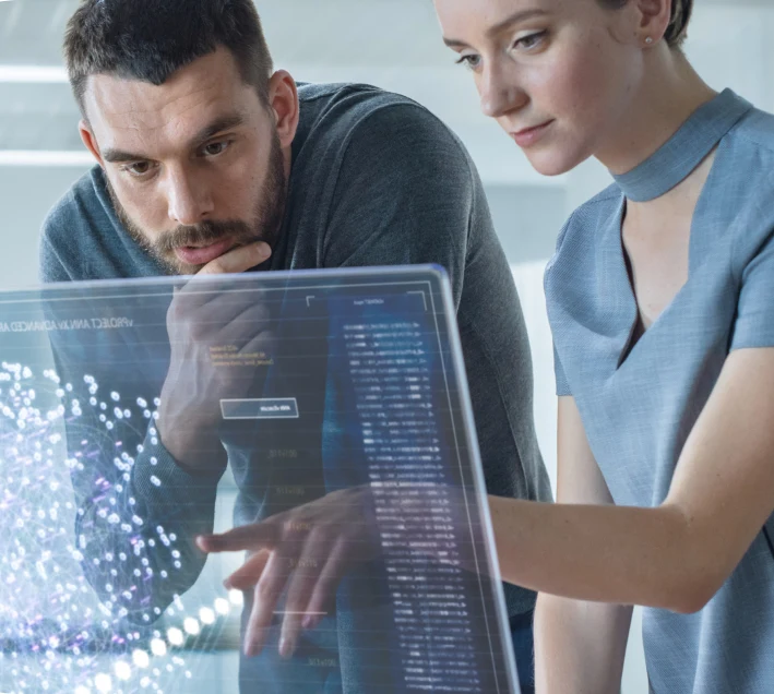 a man and woman looking at a transparent computer screen