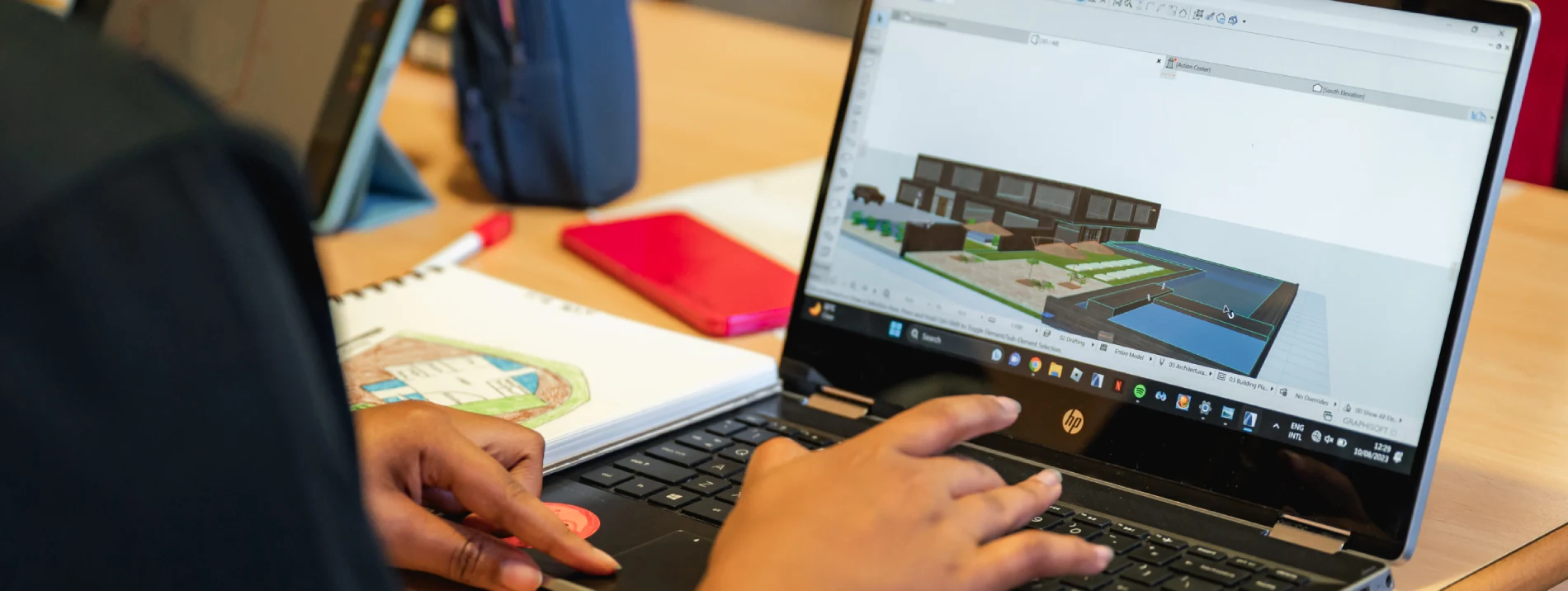 a person using a laptop that shows a house