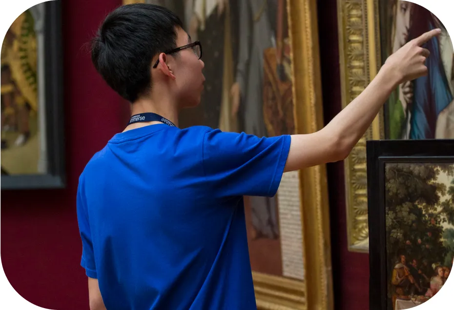 A student pointing at a painting.