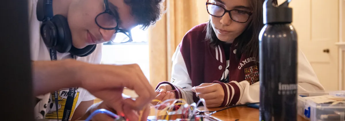 2 students working using electronics