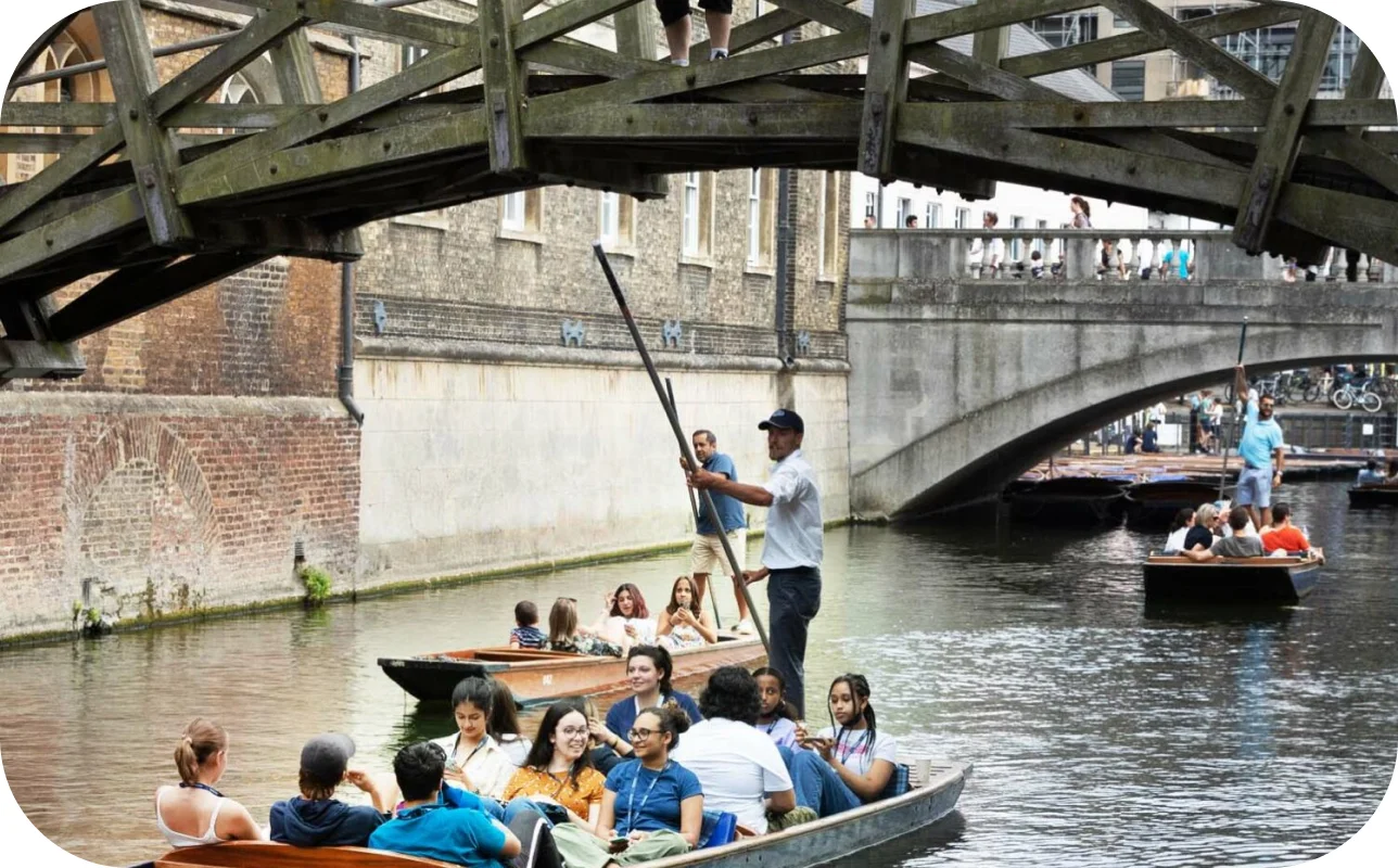 a group of people in a boat under a bridge