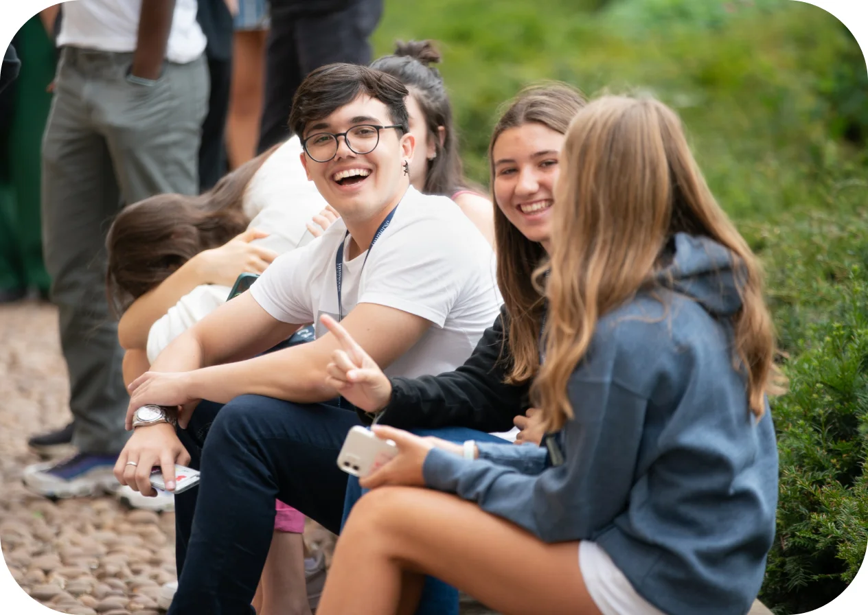 Group of people laughing and talking outside.