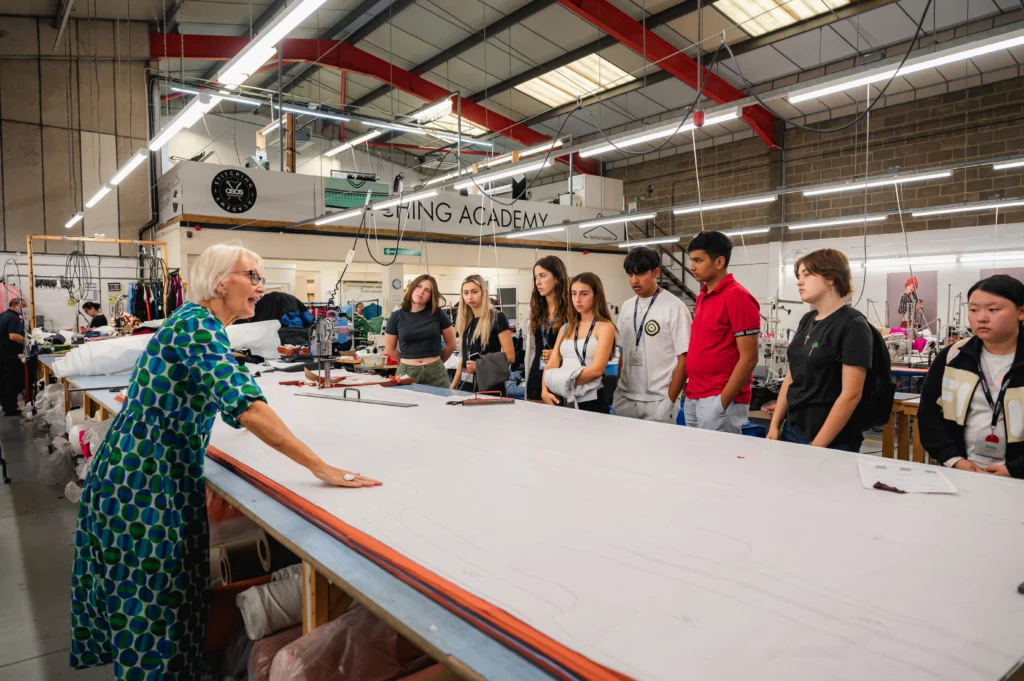 Teacher of stitching academy explaining to the students