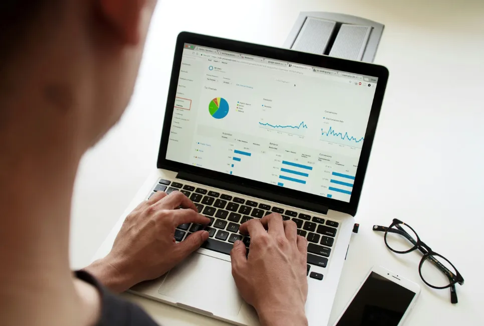 Man on laptop using Google Analytics for research