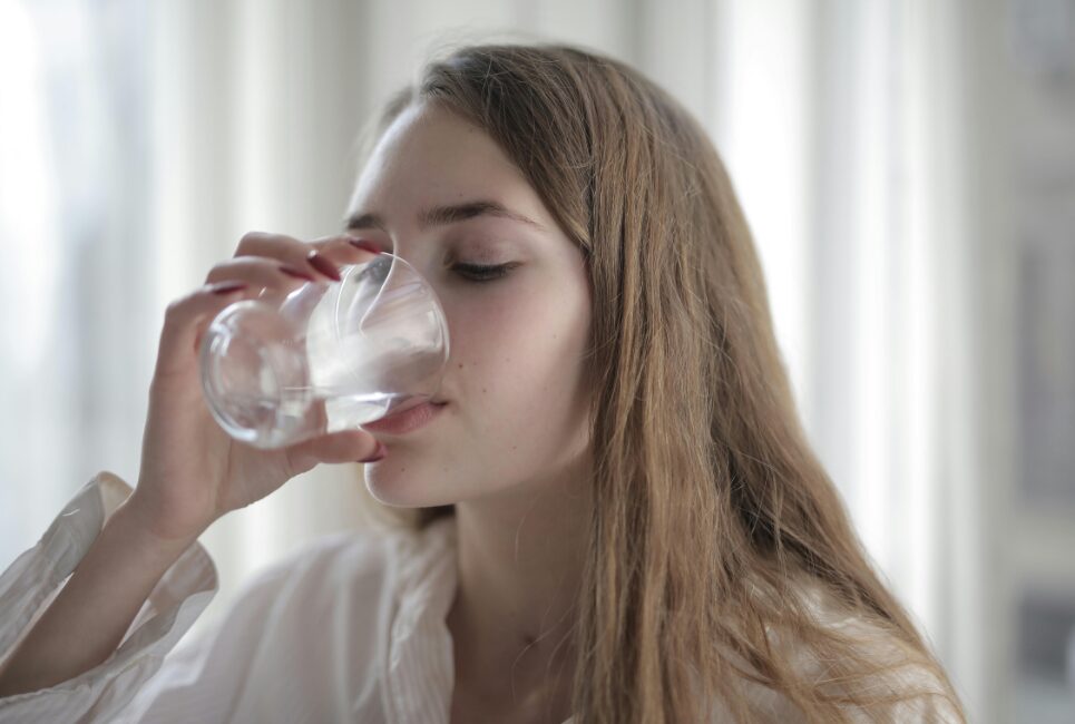 Girl drinking a glass of water 