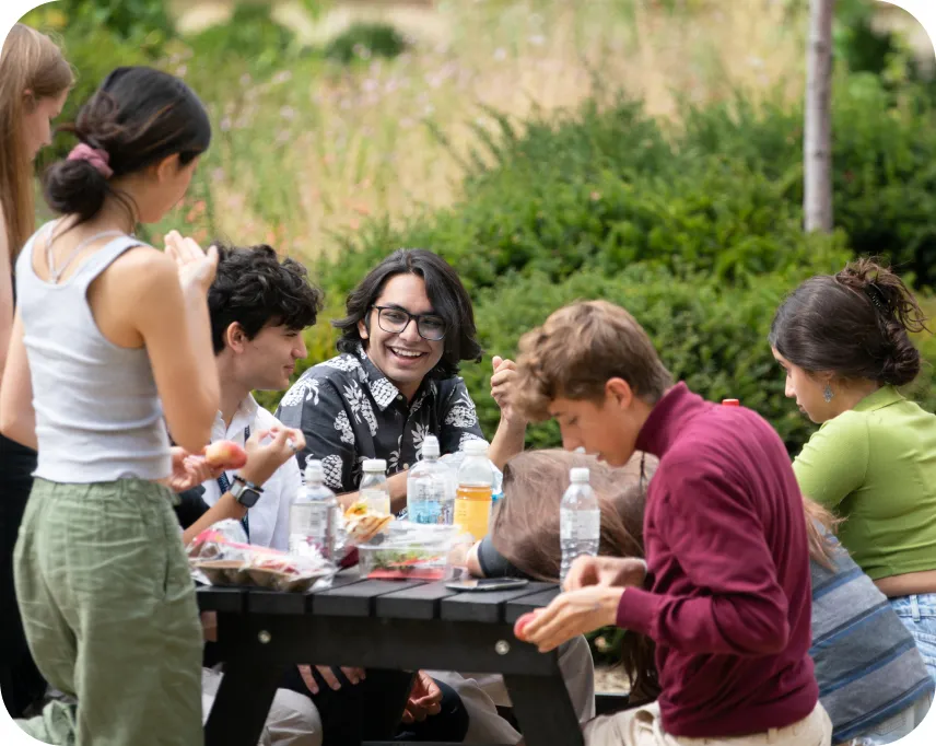 a group of students talking at the table