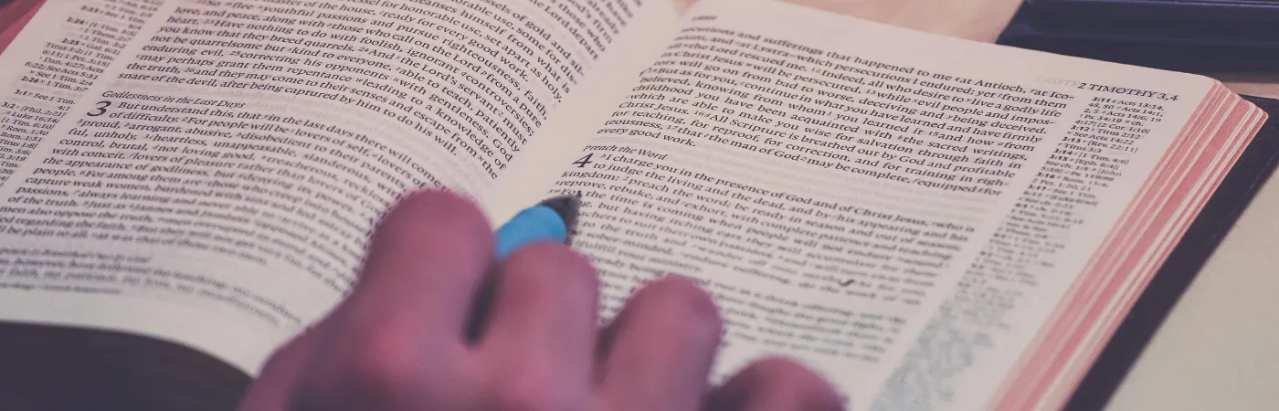 Student writing notes in text book