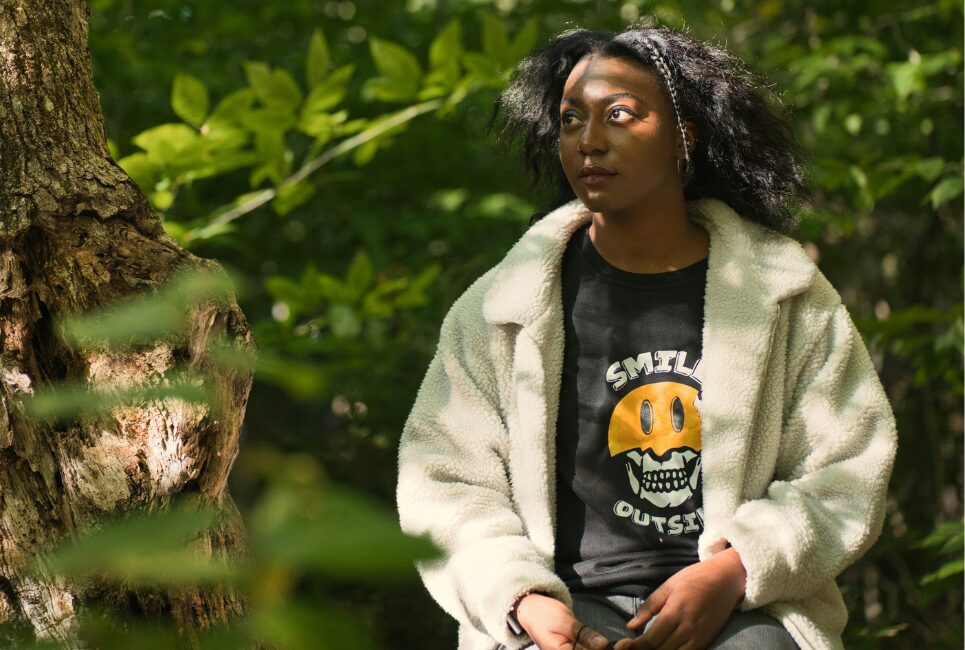 Student sitting outside in nature 