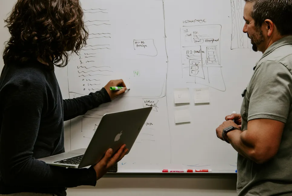 Workers mapping ideas out on a board