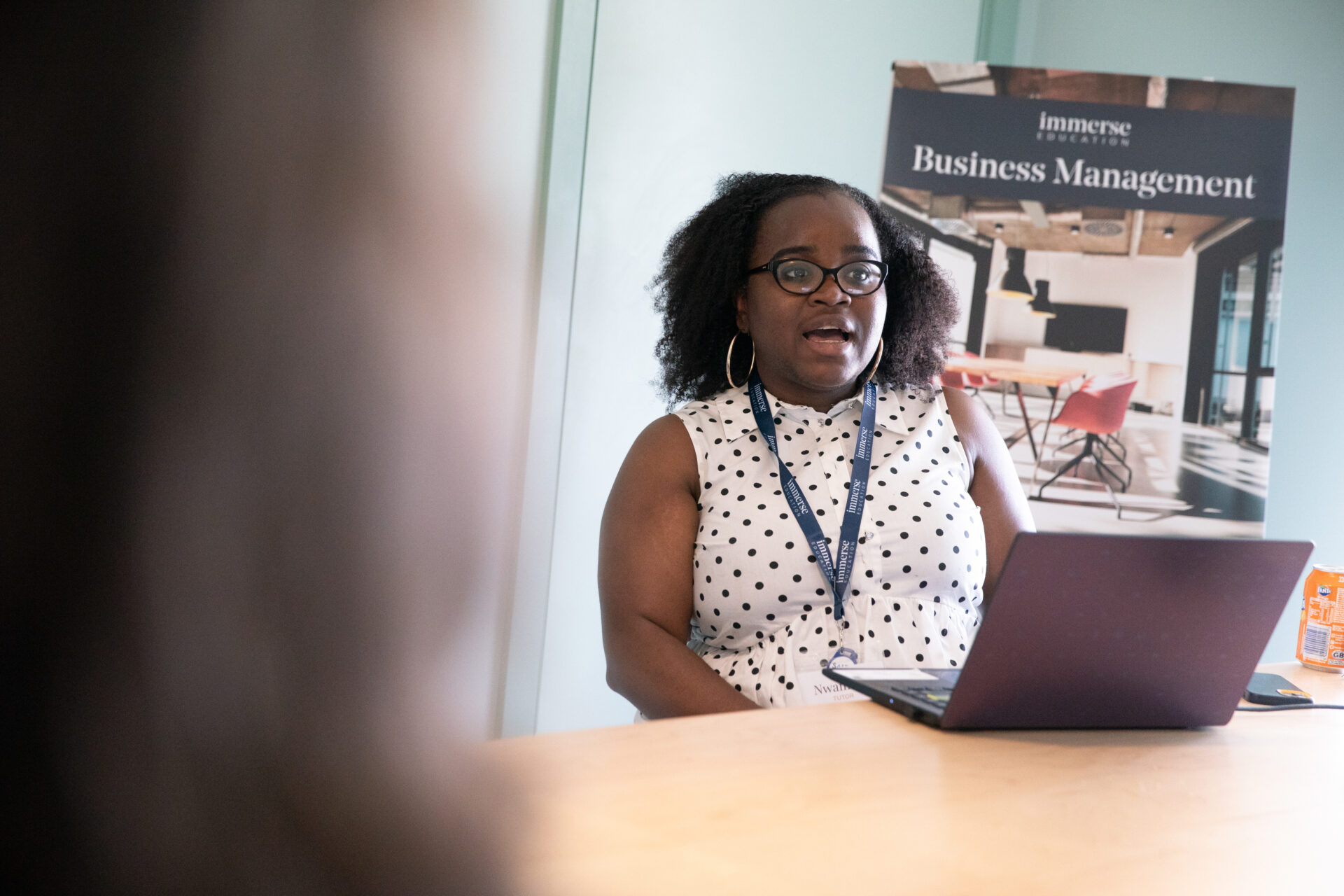 A business management tutor delivering a class