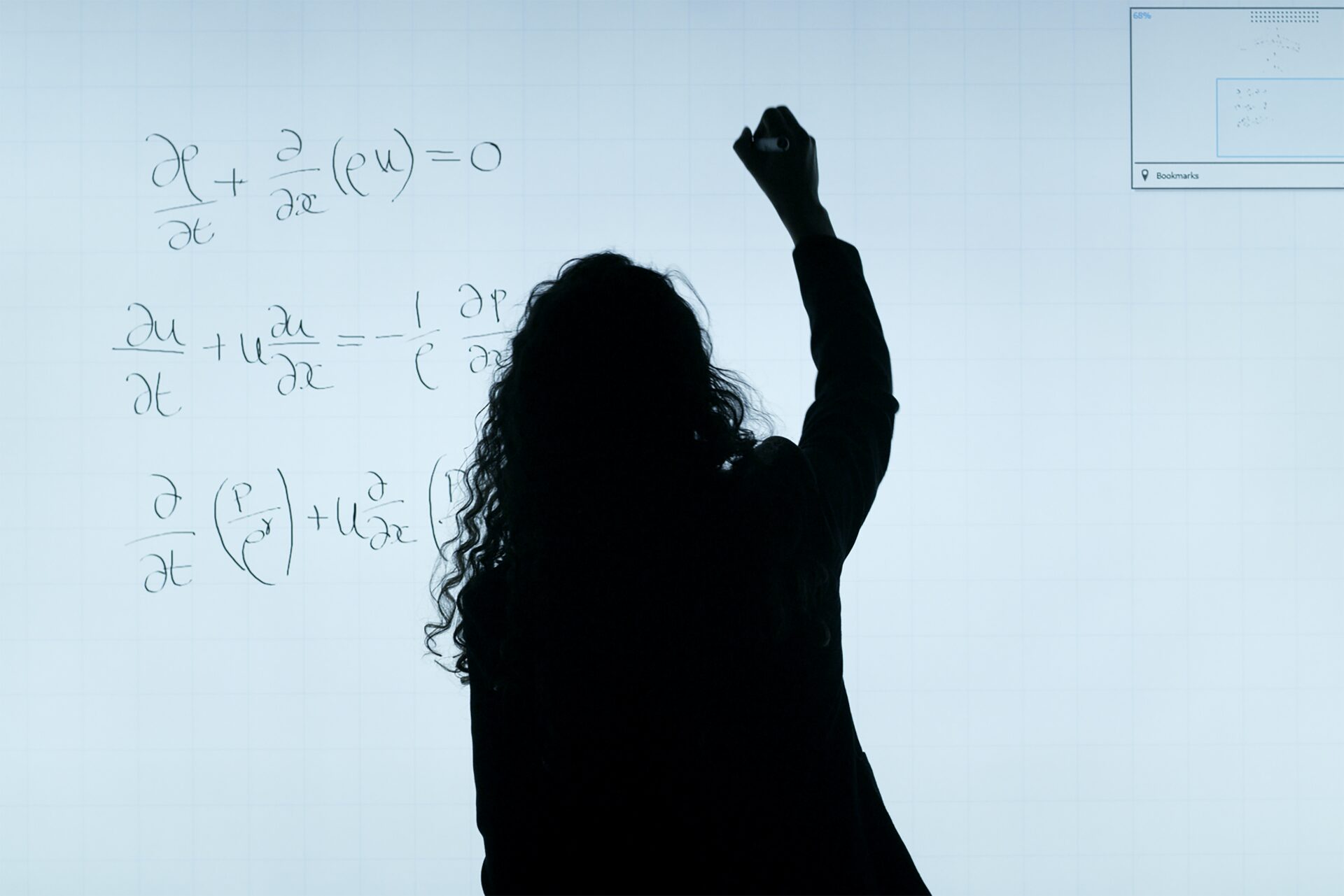 Student working out a mathematics problem on a whiteboard