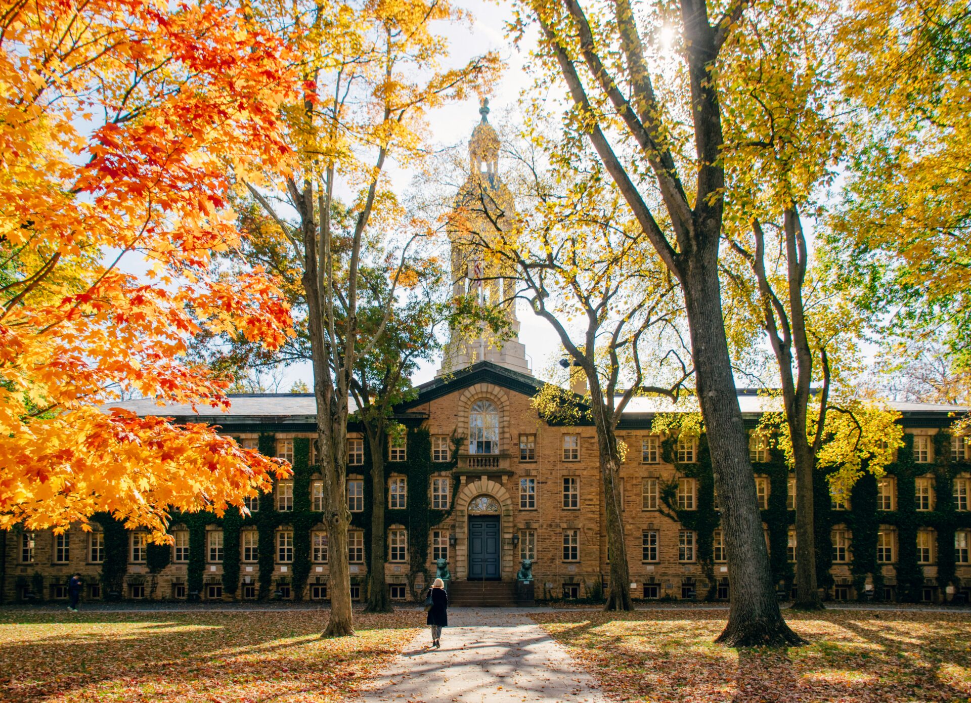 Princeton university buiilding framed by autumn leaves